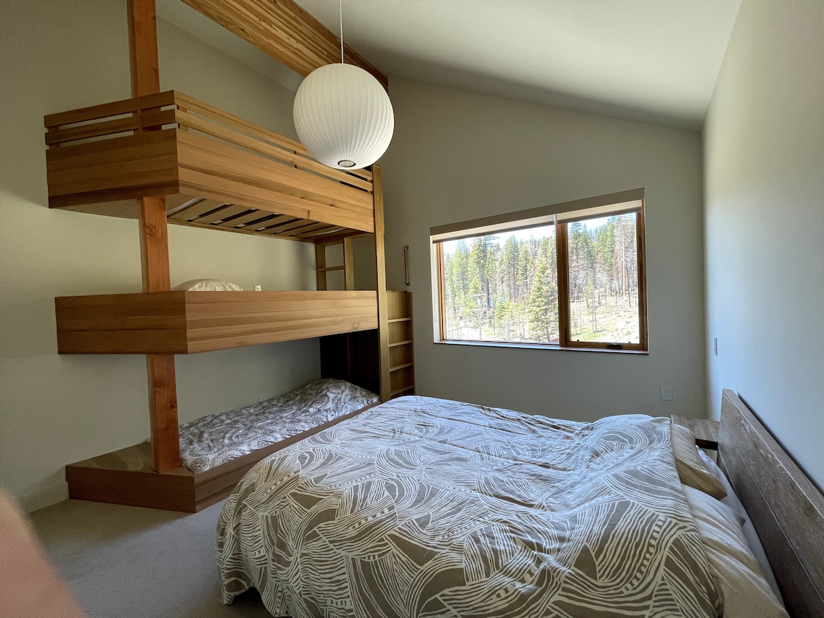 Bunk room with queen bed and 3-level bunk beds