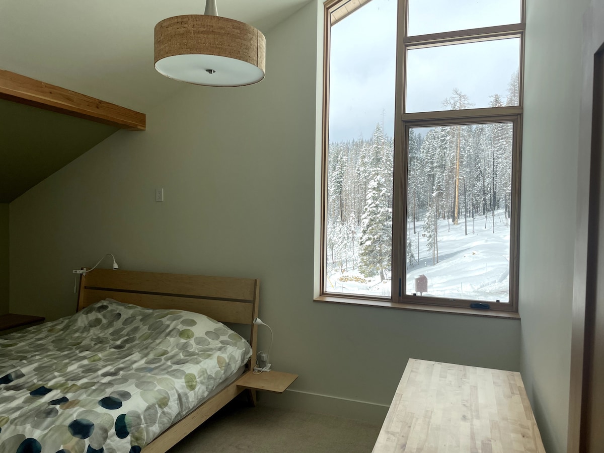 Bedroom with king bed and sit-to-stand desk