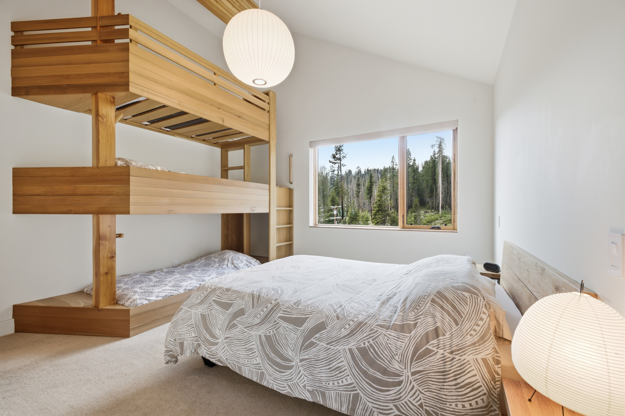 Bunk room full view with 3-level bunk beds and forest window