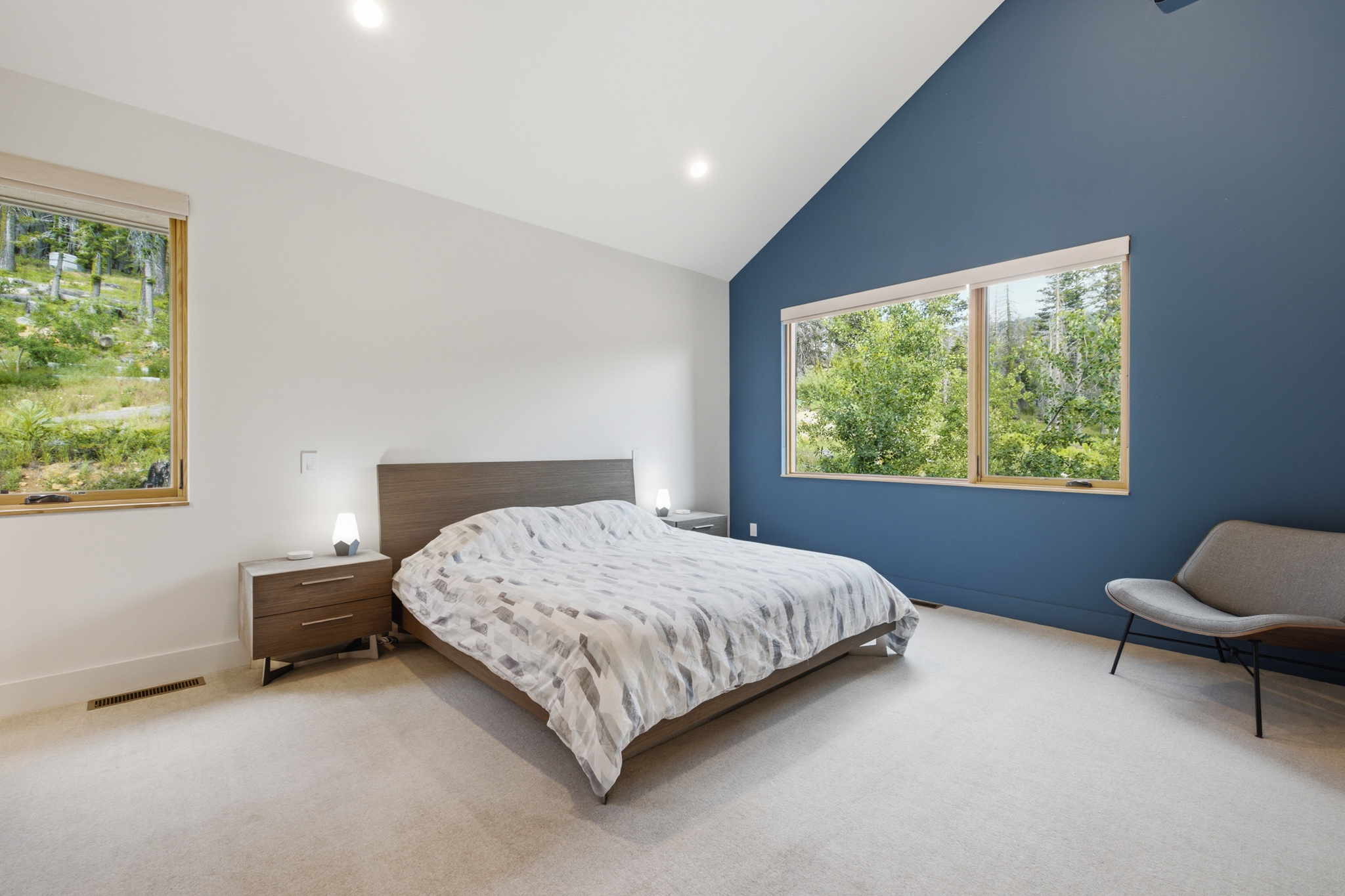 Master bedroom with king bed and blue accent wall