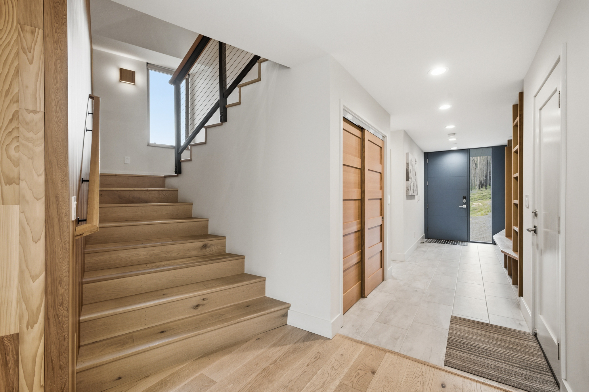Entryway with open wood staircase and front door