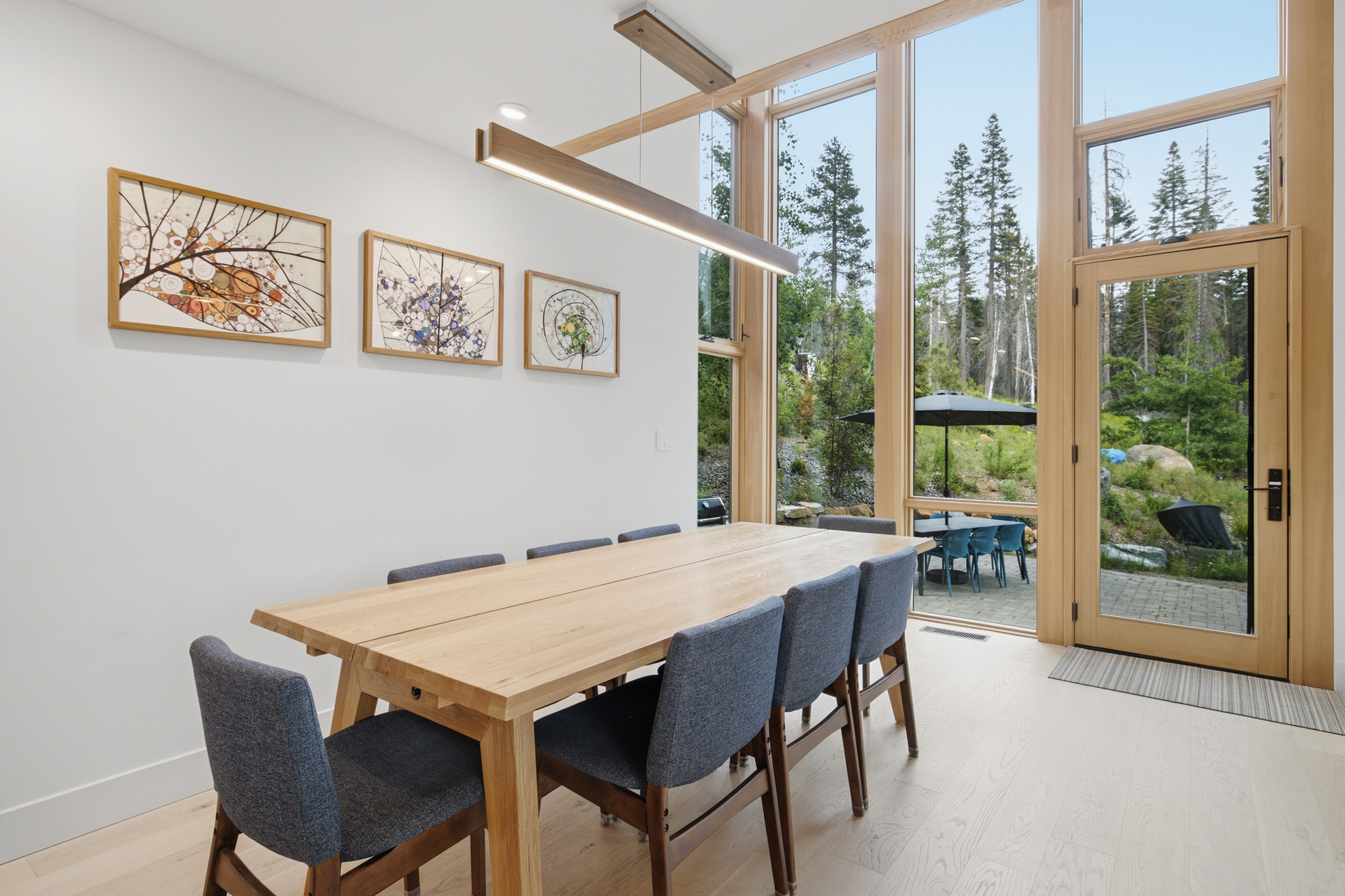 Dining area with wood table and floor-to-ceiling windows