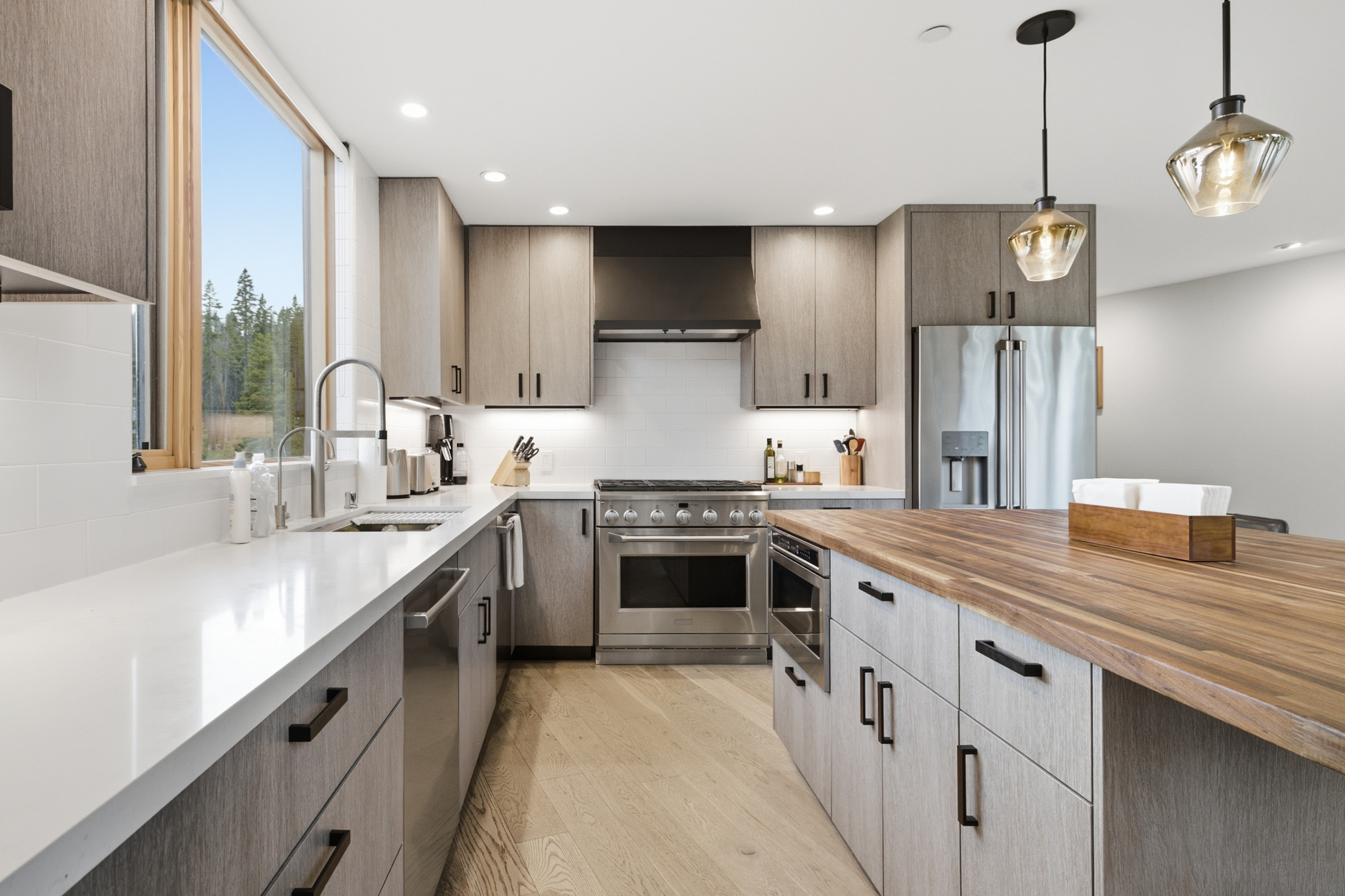 Kitchen with gas range, cabinets, and butcher block island