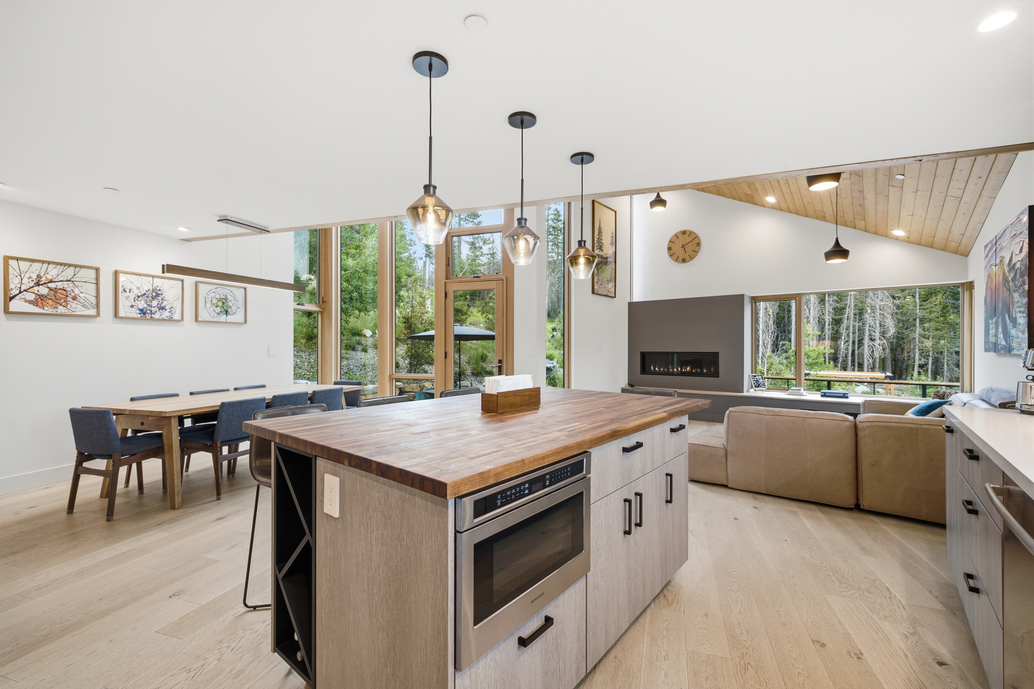 Kitchen island in foreground with dining and living room behind