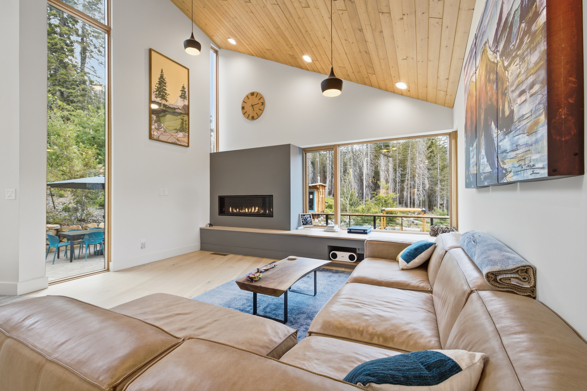 Living room with fireplace and view to outdoor patio and garden