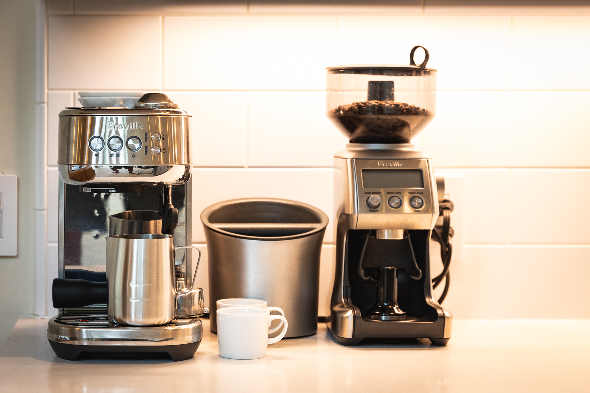 Breville espresso machine and coffee grinder on kitchen counter